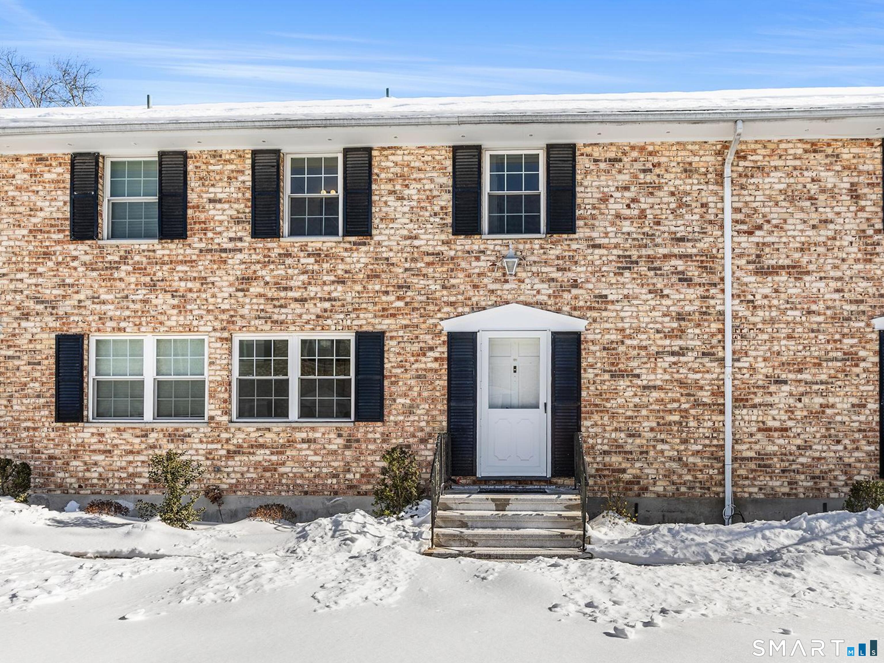 39 Woodway Road, Unit C7 Stamford, CT 06907 - Photo 1 of 1 a front view of a house with a yard and garage