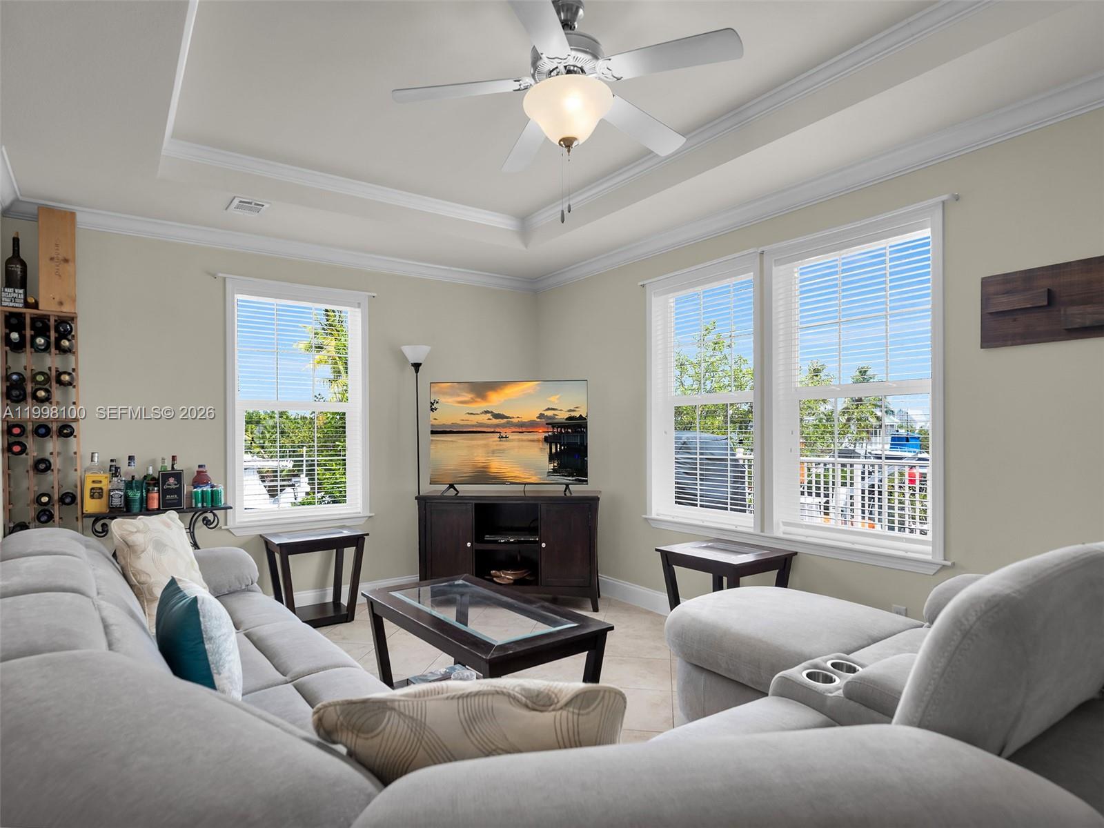 437 Pirates Road Summerland Key, FL 33042 - Photo 14 of 39 a living room with furniture a large window and a flat screen tv