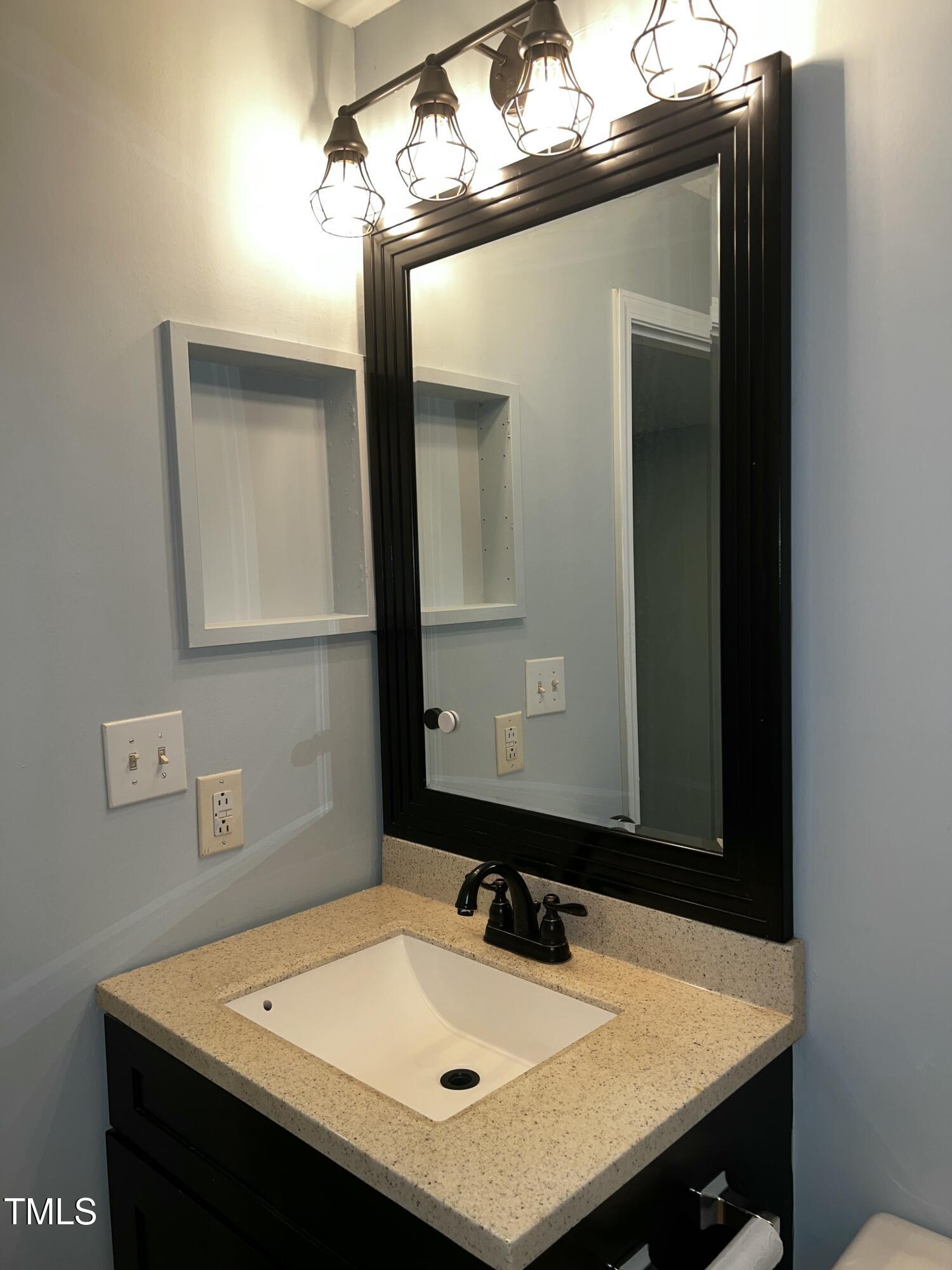 4519 Edwards Mill Road, Unit J Raleigh, NC 27612 - Photo 12 of 20 a bathroom with a sink and a mirror