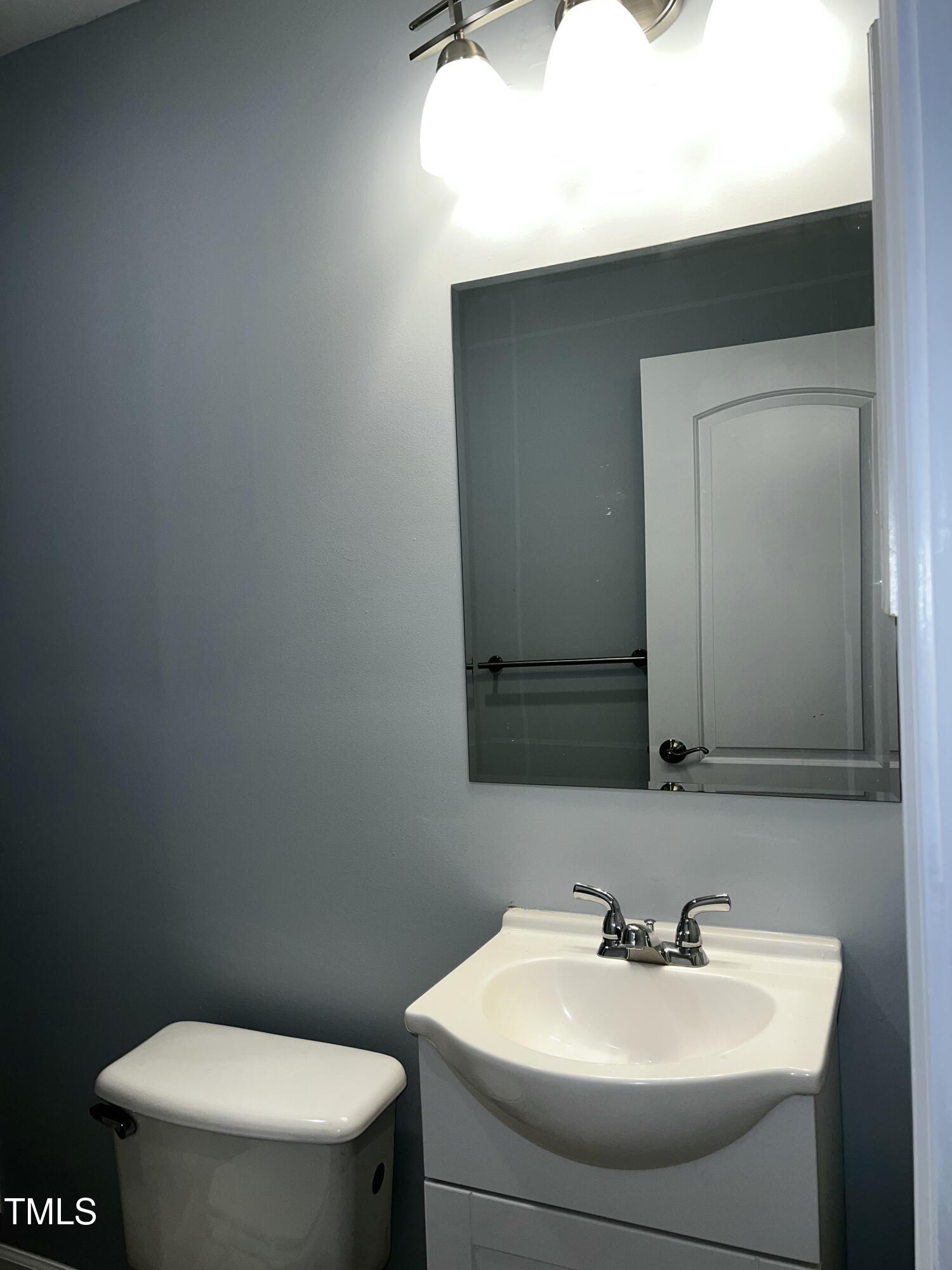 4519 Edwards Mill Road, Unit J Raleigh, NC 27612 - Photo 16 of 20 a bathroom with a sink and a toilet