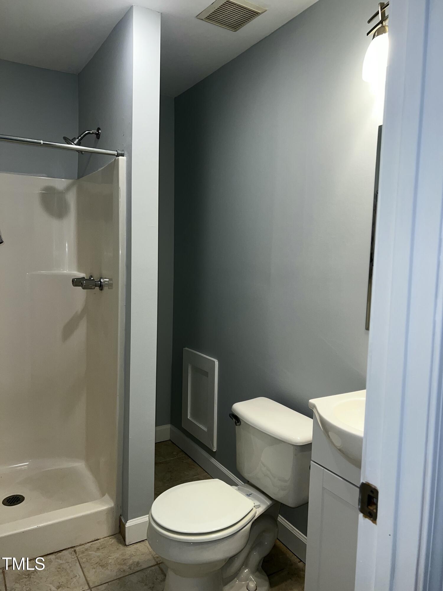 4519 Edwards Mill Road, Unit J Raleigh, NC 27612 - Photo 17 of 20 a white toilet sitting next to a bathroom sink