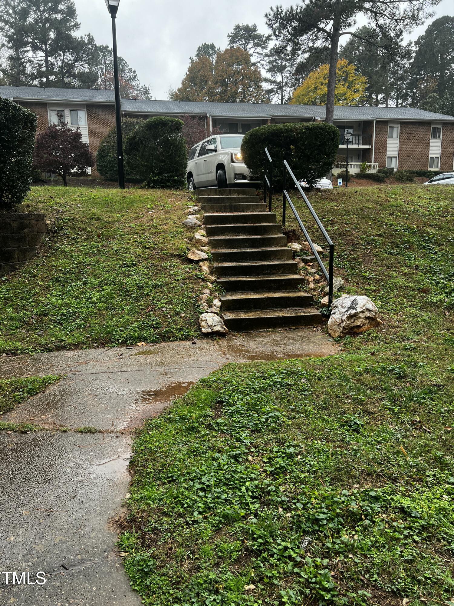 4519 Edwards Mill Road, Unit J Raleigh, NC 27612 - Photo 3 of 20 a view of a house with a yard