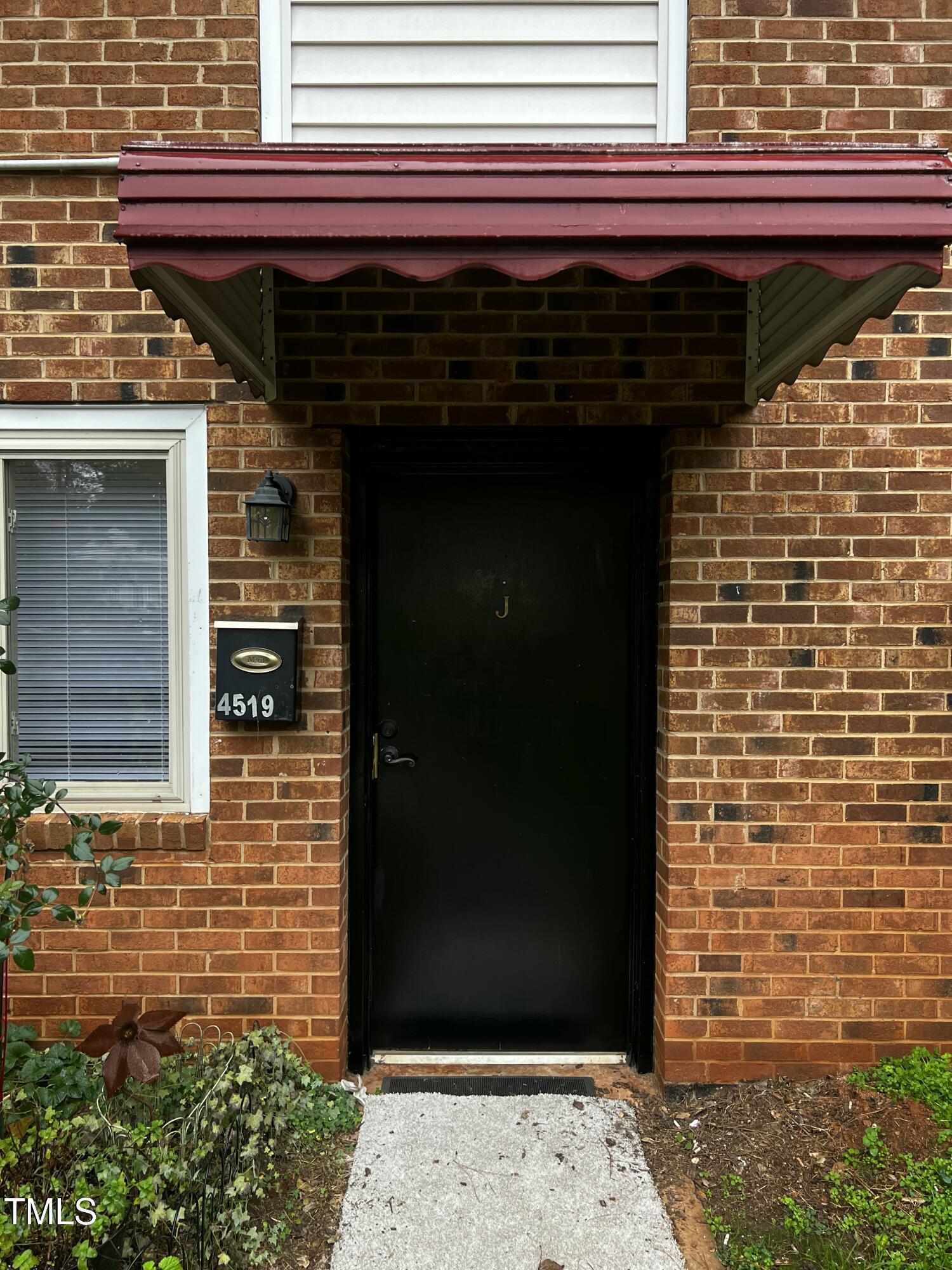 4519 Edwards Mill Road, Unit J Raleigh, NC 27612 - Photo 4 of 20 a view of door with wooden door