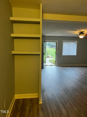a view of a room with wooden floor
