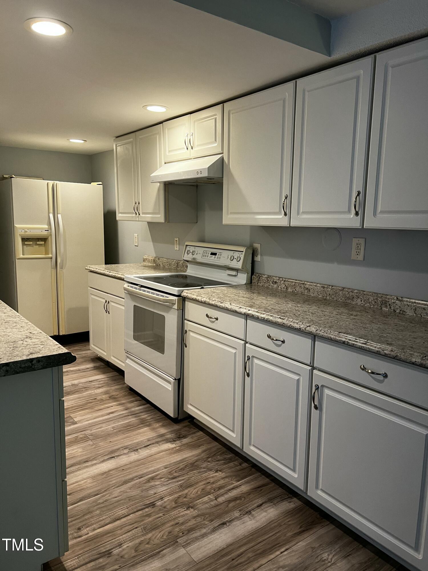 4519 Edwards Mill Road, Unit J Raleigh, NC 27612 - Photo 8 of 20 a kitchen with stainless steel appliances granite countertop a sink a stove a refrigerator and cabinets