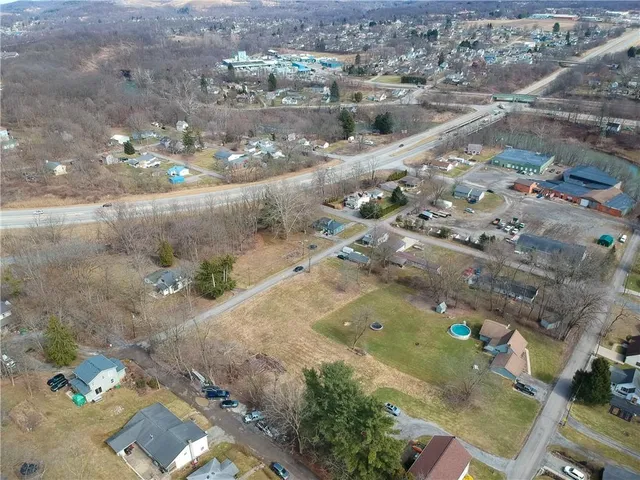 an aerial view of residential houses with outdoor space