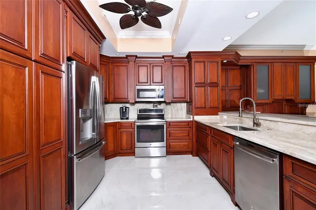 a kitchen with stainless steel appliances granite countertop a refrigerator stove and microwave