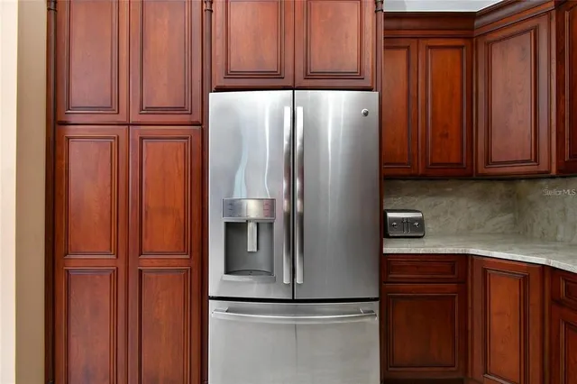 a view of a kitchen with granite countertop a sink and dishwasher with wooden cabinets
