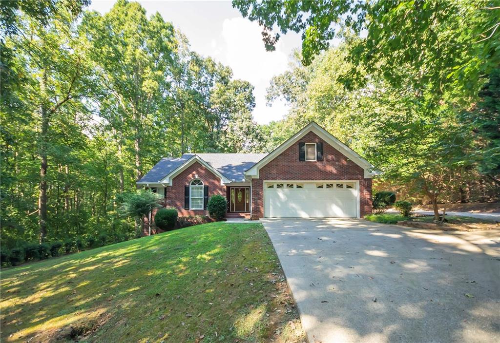 Beautiful brick home nestled in over 2 acres of land in a quiet, estate-style neighborhood. 