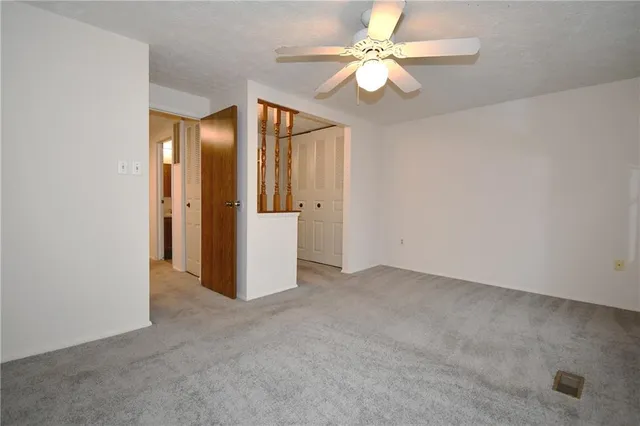 an empty room with fan and fan