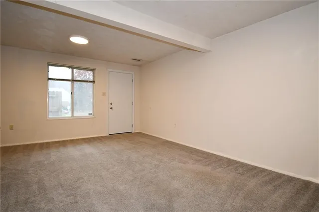 an empty room with windows and closet