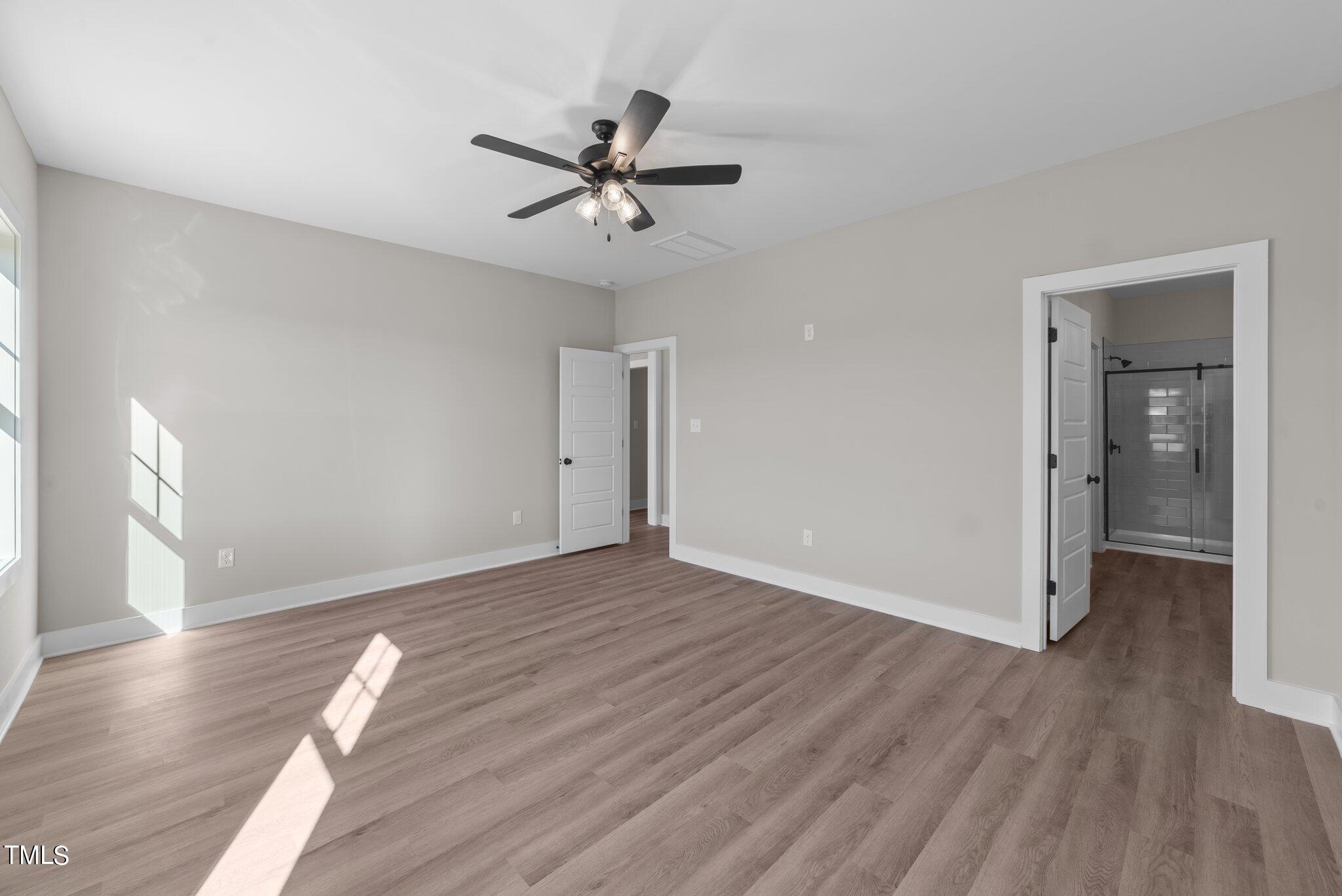 6041 Farmwood Loop Wilson, NC 27896 - Photo 18 of 38 a view of empty room with wooden floor and fan