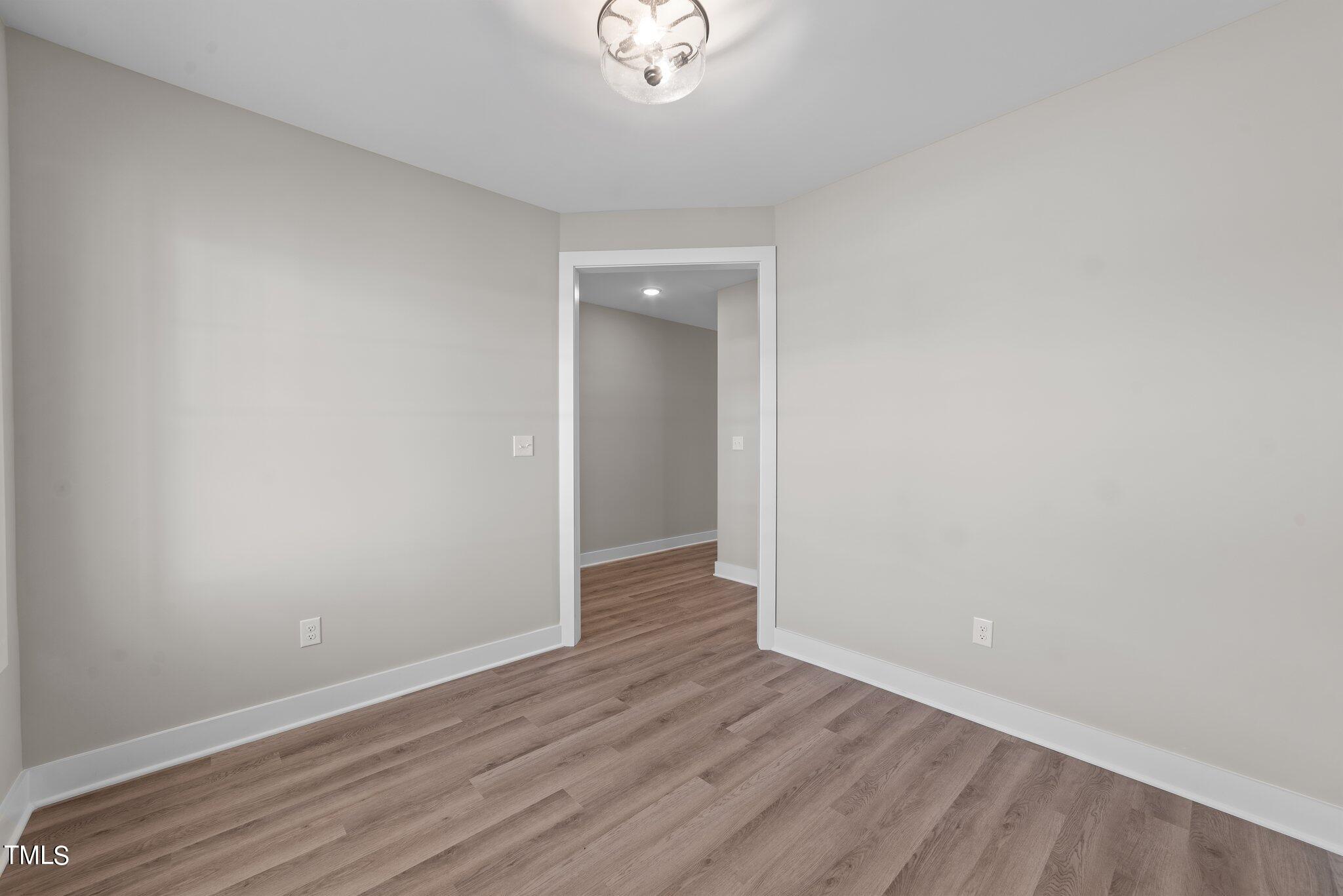 6041 Farmwood Loop Wilson, NC 27896 - Photo 25 of 38 a view of an empty room with wooden floor