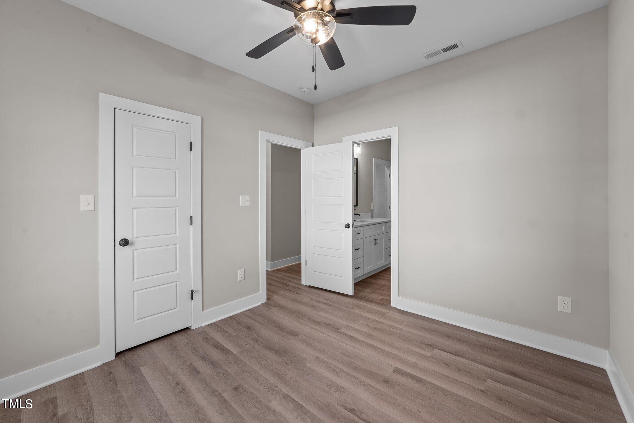 6041 Farmwood Loop Wilson, NC 27896 - Photo 29 of 38 an empty room with wooden floor and ceiling fan