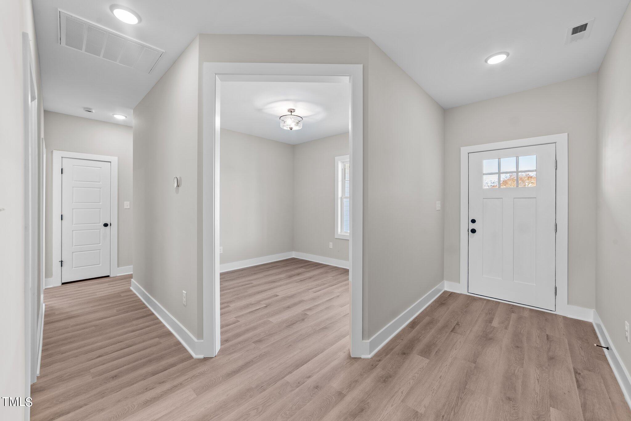 6041 Farmwood Loop Wilson, NC 27896 - Photo 3 of 38 wooden floor in an empty room with a window
