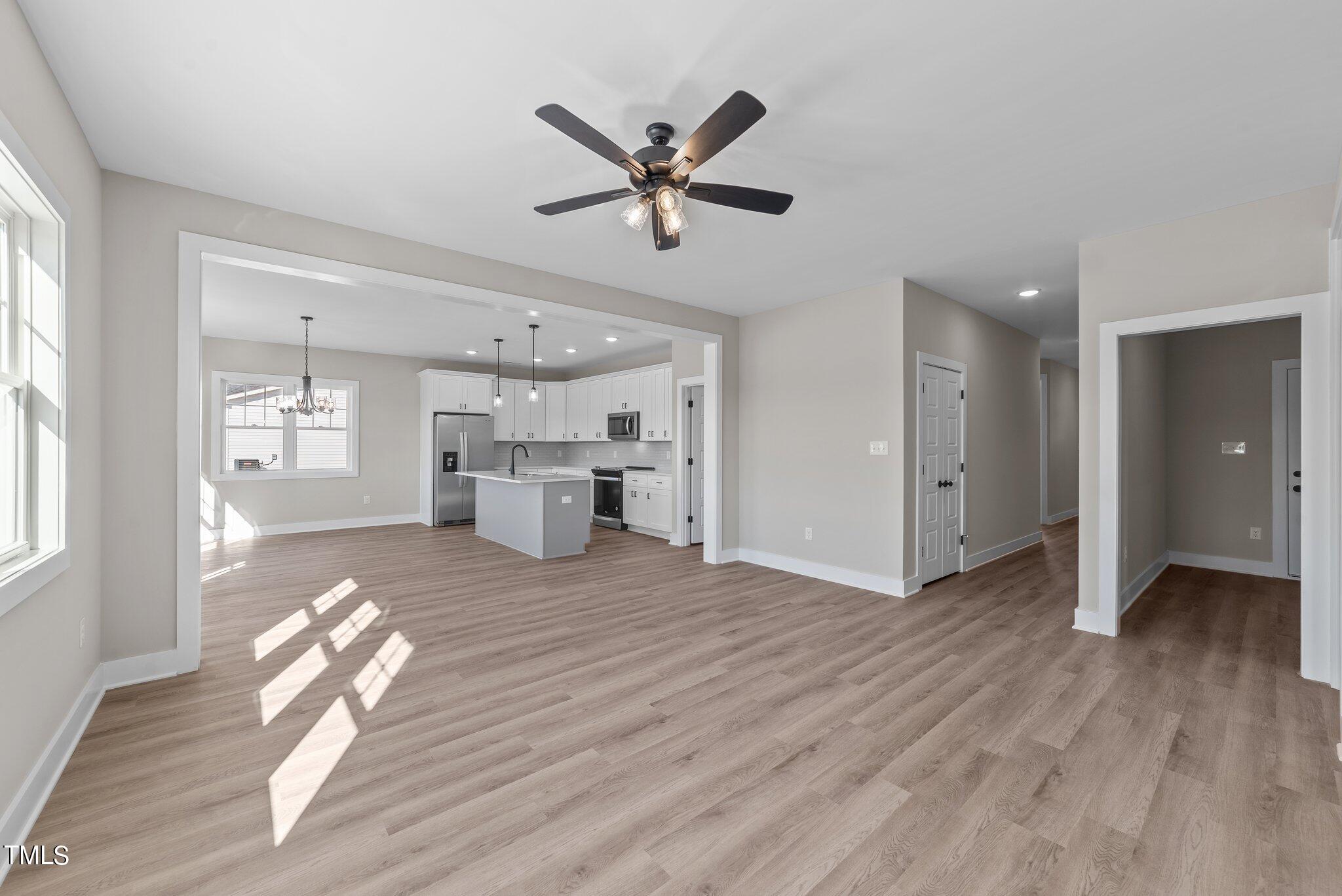 6041 Farmwood Loop Wilson, NC 27896 - Photo 7 of 38 a view of livingroom with hardwood floor and a ceiling fan