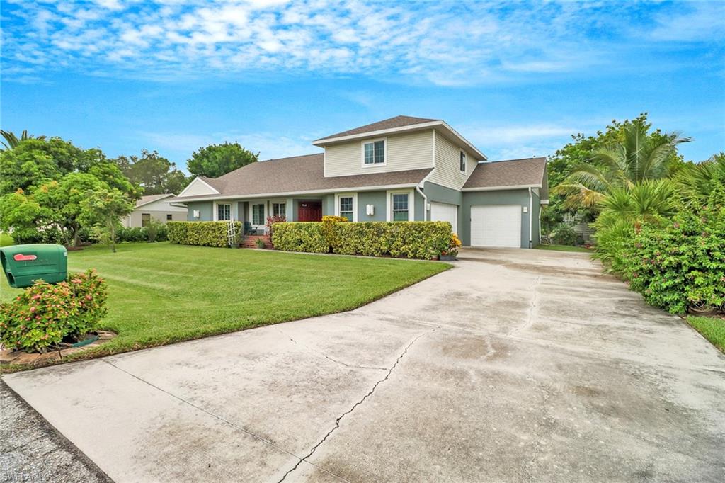17532 Ingram Road Fort Myers, FL 33967 - Photo 1 of 46 a front view of a house with a yard