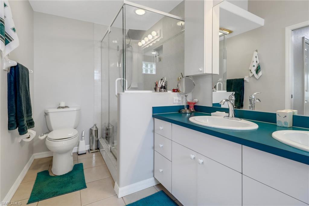17532 Ingram Road Fort Myers, FL 33967 - Photo 11 of 46 a bathroom with a granite countertop sink toilet and a mirror
