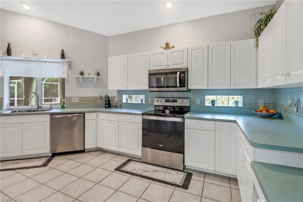 17532 Ingram Road Fort Myers, FL 33967 - Photo 19 of 46 a kitchen with granite countertop cabinets stainless steel appliances and a counter space