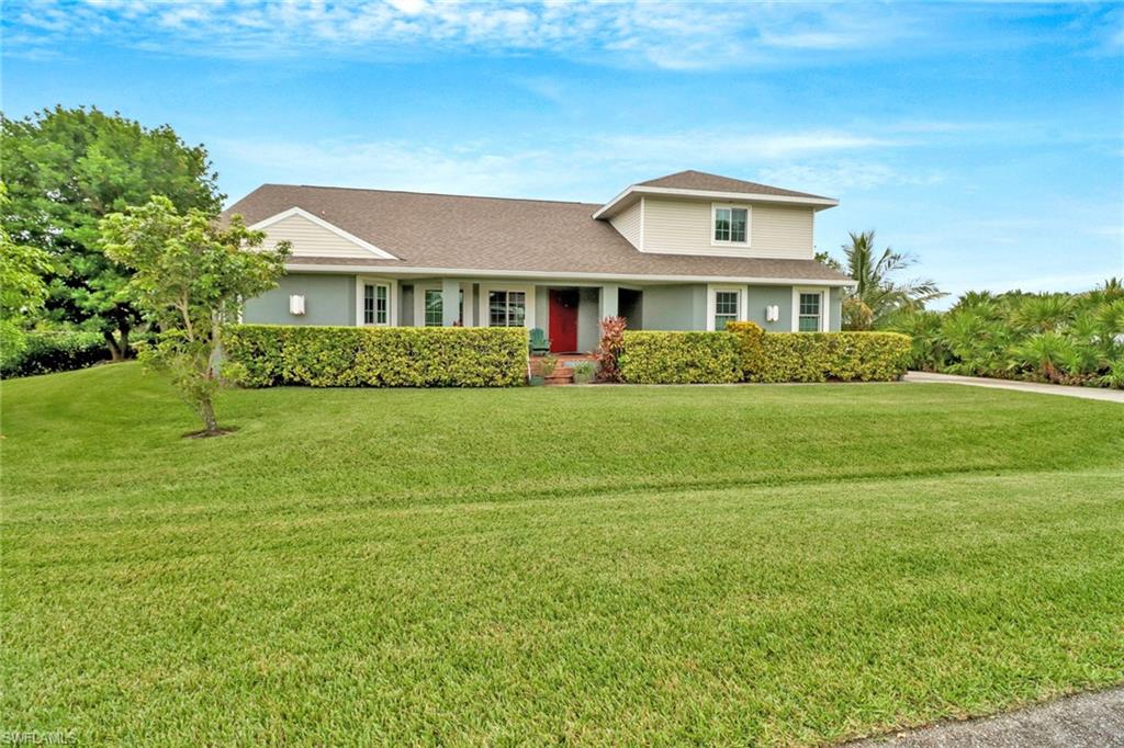 17532 Ingram Road Fort Myers, FL 33967 - Photo 2 of 46 a front view of a house with a garden