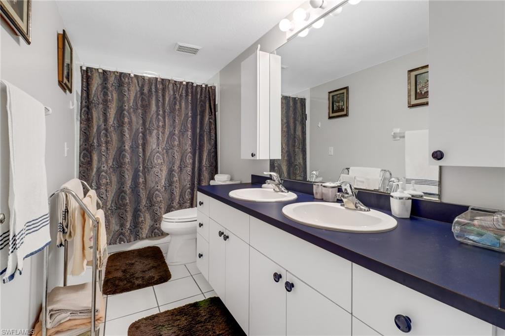 17532 Ingram Road Fort Myers, FL 33967 - Photo 23 of 46 a bathroom with a double vanity sink toilet and shower