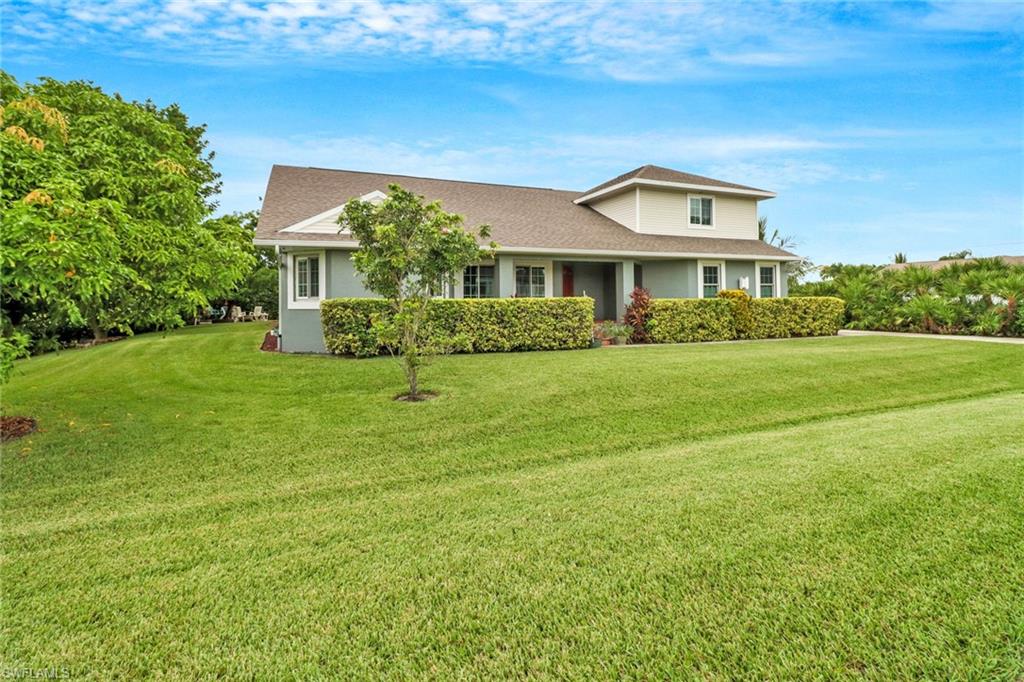 17532 Ingram Road Fort Myers, FL 33967 - Photo 3 of 46 a front view of a house with a garden