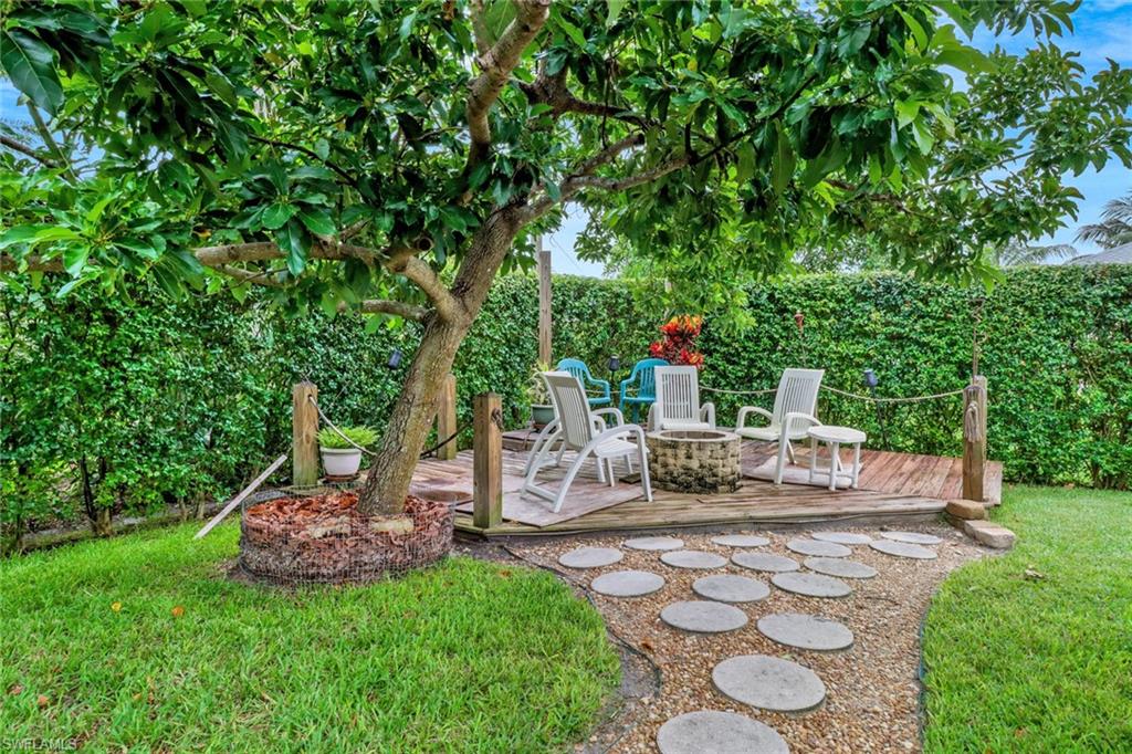 17532 Ingram Road Fort Myers, FL 33967 - Photo 32 of 46 a view of a patio with table and chairs potted plants and large tree