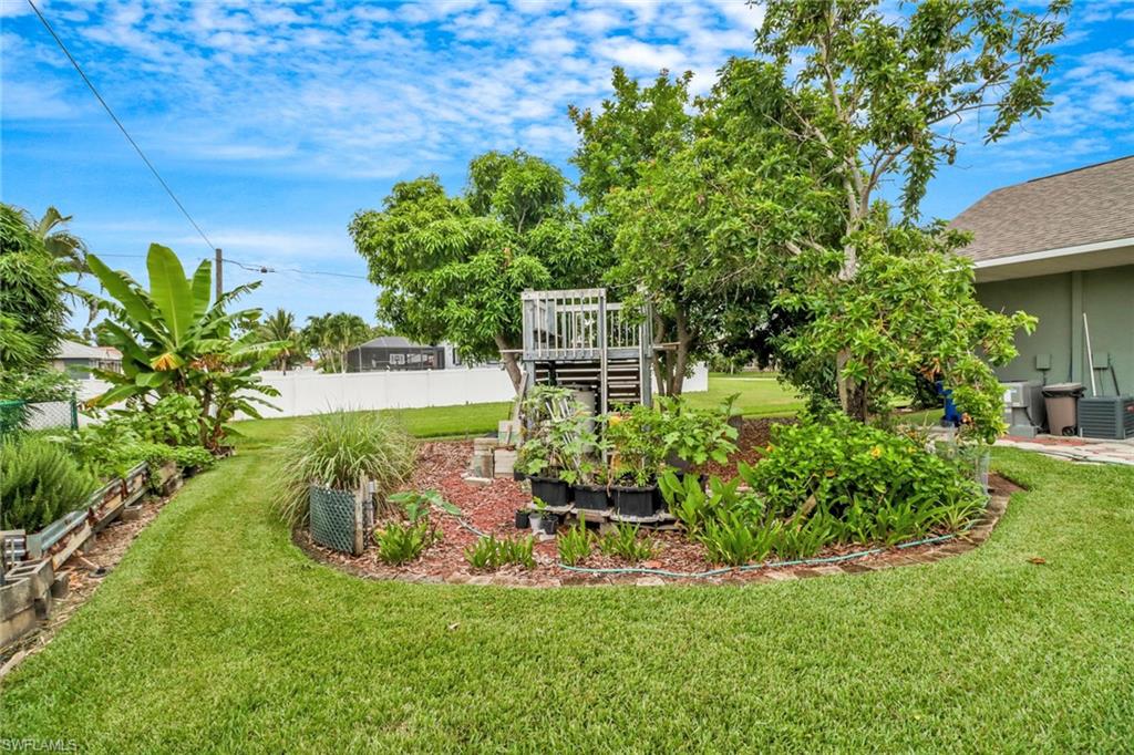 17532 Ingram Road Fort Myers, FL 33967 - Photo 35 of 46 a view of a garden with a bench