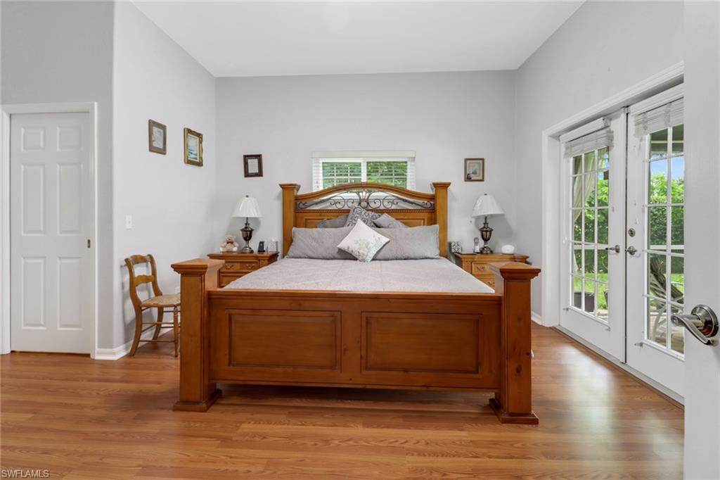 17532 Ingram Road Fort Myers, FL 33967 - Photo 8 of 46 a bedroom with a bed and wooden floor