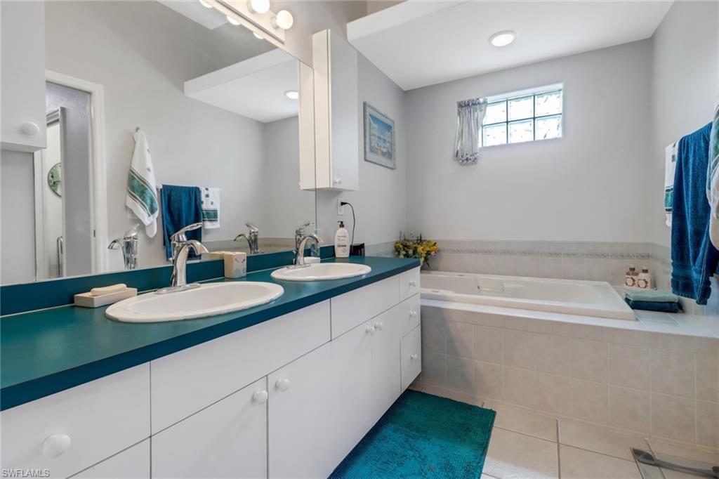 17532 Ingram Road Fort Myers, FL 33967 - Photo 10 of 46 a bathroom with a granite countertop sink and a mirror