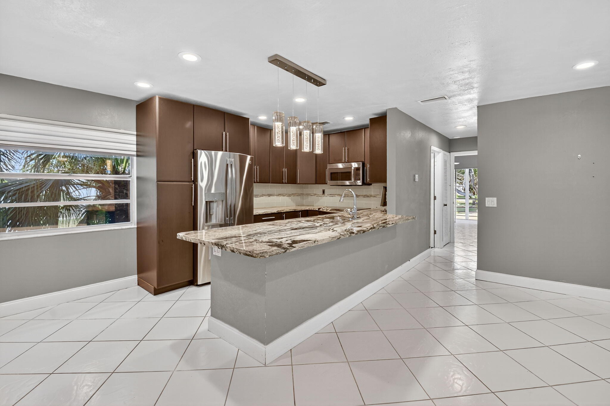 a kitchen with stainless steel appliances granite countertop a refrigerator and a stove