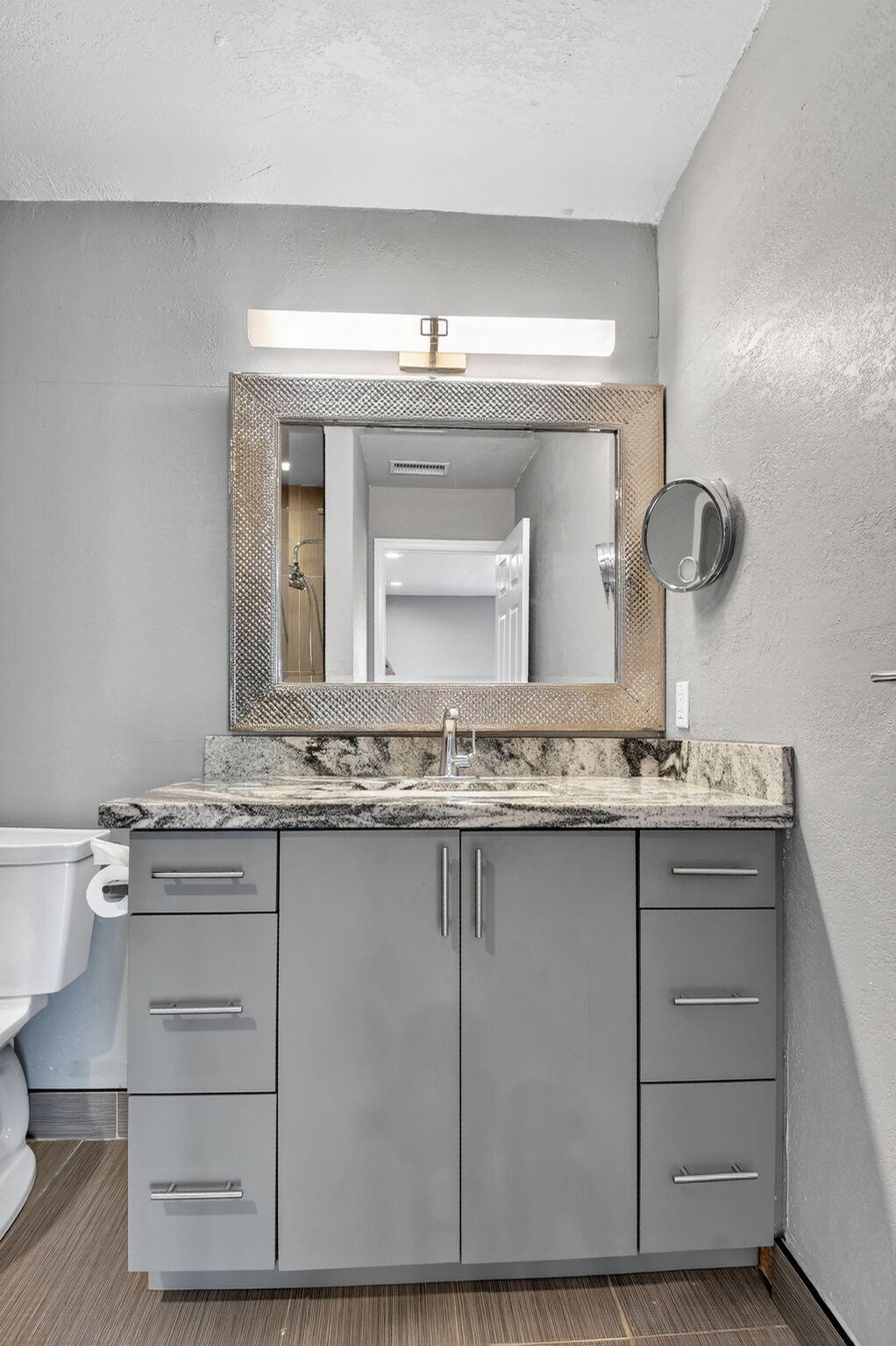 624 Flanders North Delray Beach, FL 33484 - Photo 22 of 44 a bathroom with a granite countertop sink a toilet and a mirror