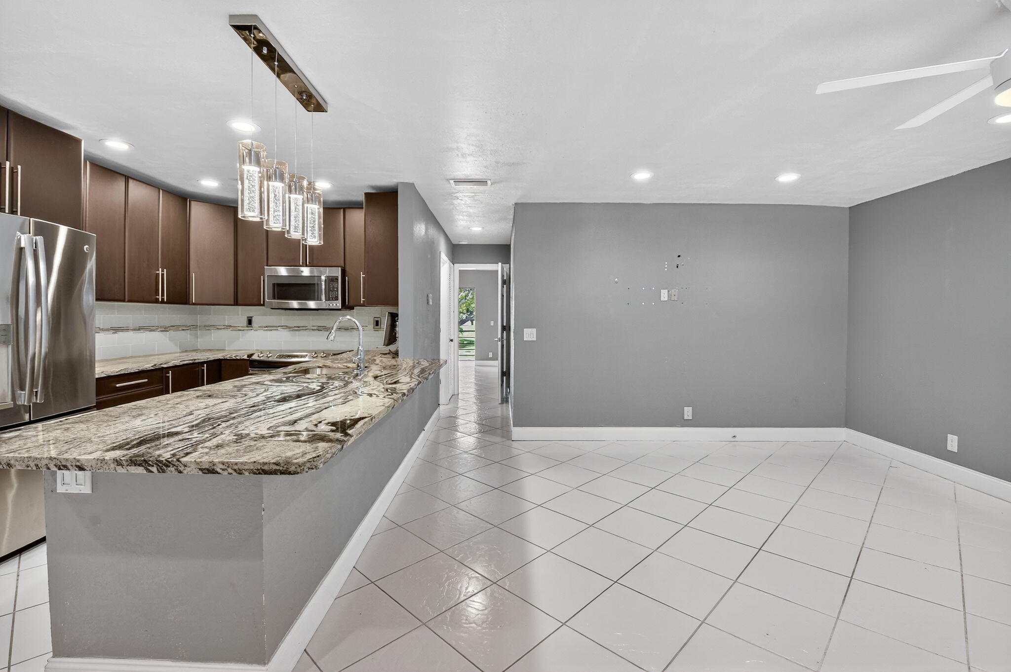 624 Flanders North Delray Beach, FL 33484 - Photo 4 of 44 a large kitchen with kitchen island a large counter top stainless steel appliances and cabinets