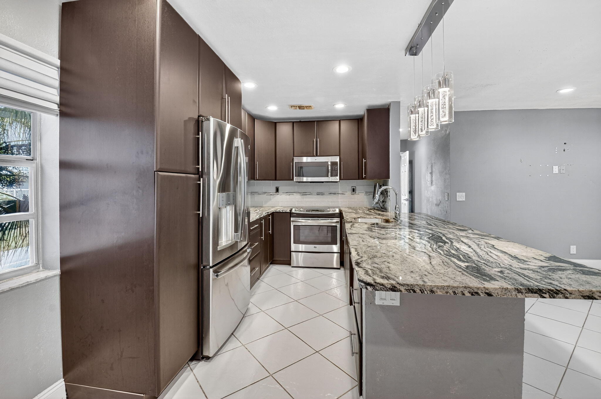 624 Flanders North Delray Beach, FL 33484 - Photo 5 of 44 a kitchen with kitchen island a counter top space appliances and cabinets