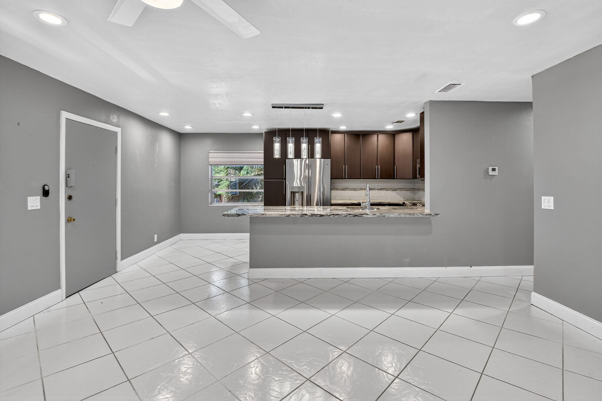 624 Flanders North Delray Beach, FL 33484 - Photo 7 of 44 a view of kitchen with granite countertop cabinets and refrigerator