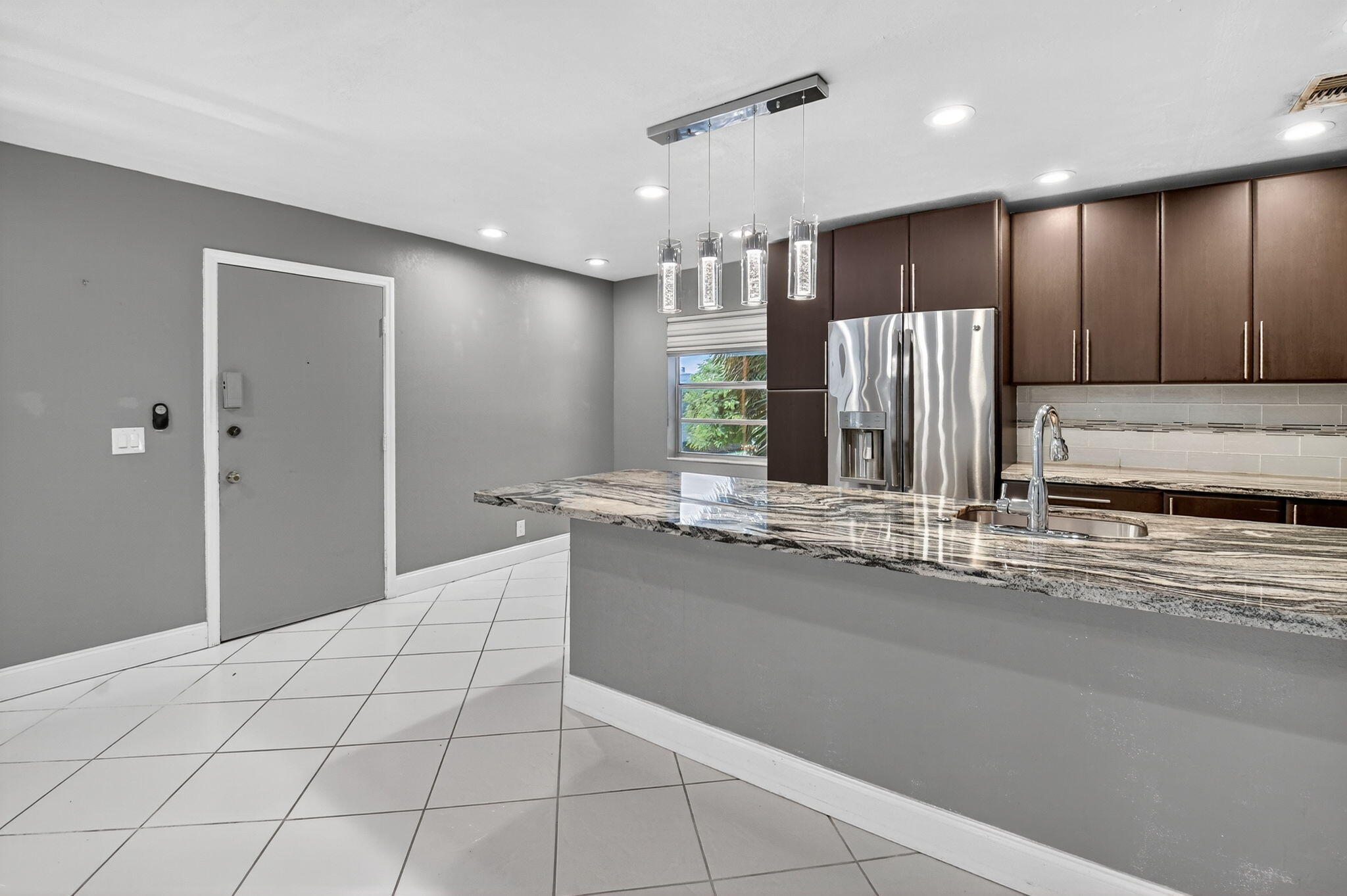 624 Flanders North Delray Beach, FL 33484 - Photo 8 of 44 a large bathroom with a large mirror vanity and shower