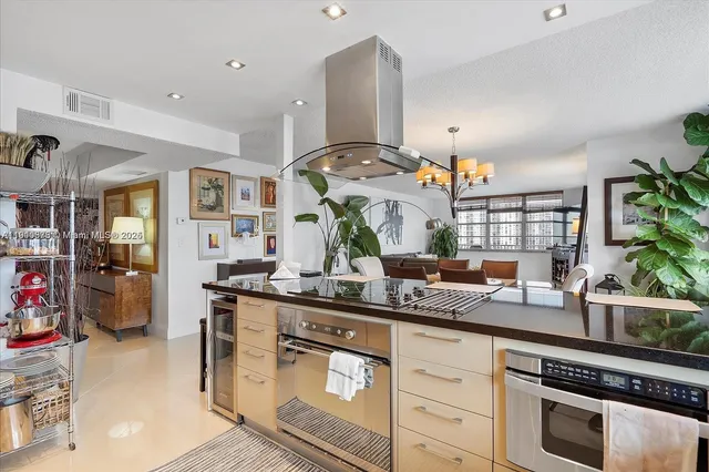 a kitchen with stainless steel appliances granite countertop a stove and a sink