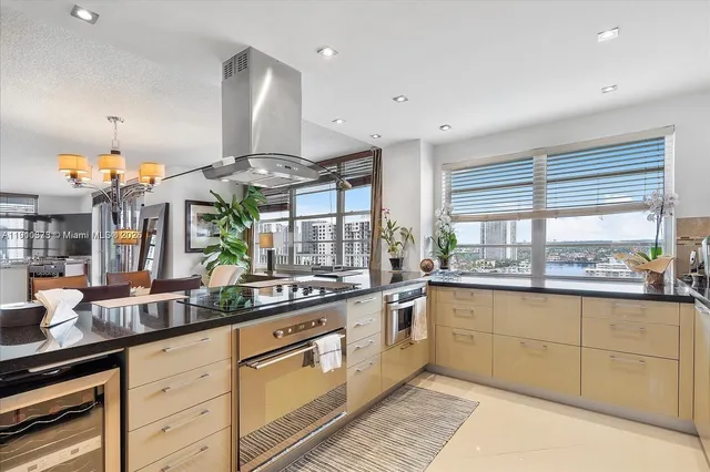 a kitchen with stainless steel appliances granite countertop a sink and cabinets