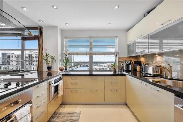 a dining room with stainless steel appliances kitchen island a table and chairs