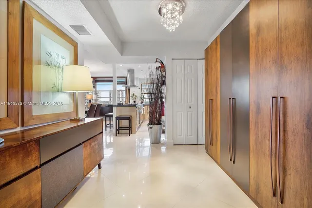 a living room with furniture a chandelier and a large window
