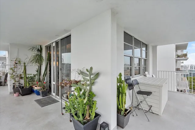 a view of a multi story residential apartment building with a yard and outdoor seating