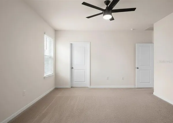 a view of an empty room with a window