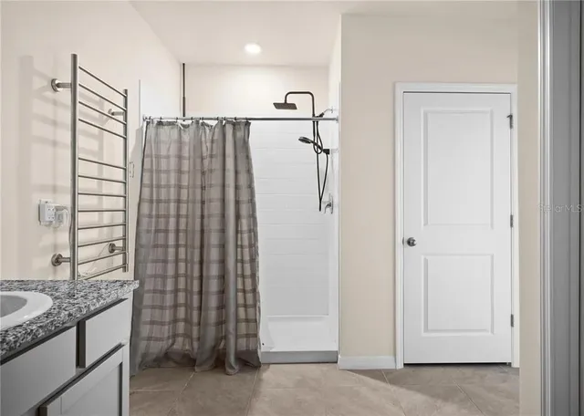 a bathroom with a shower and a sink