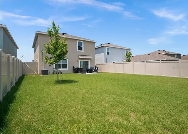 a view of a house with a back yard