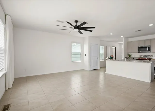 a view of a kitchen with microwave and a stove top oven