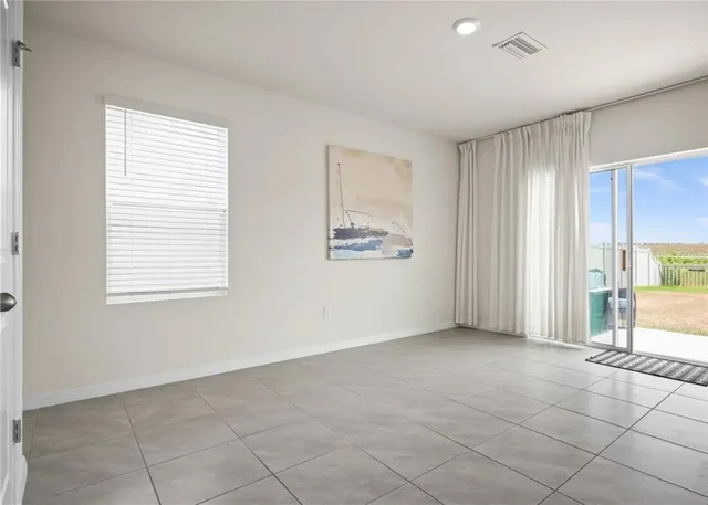 an empty room with windows and closet