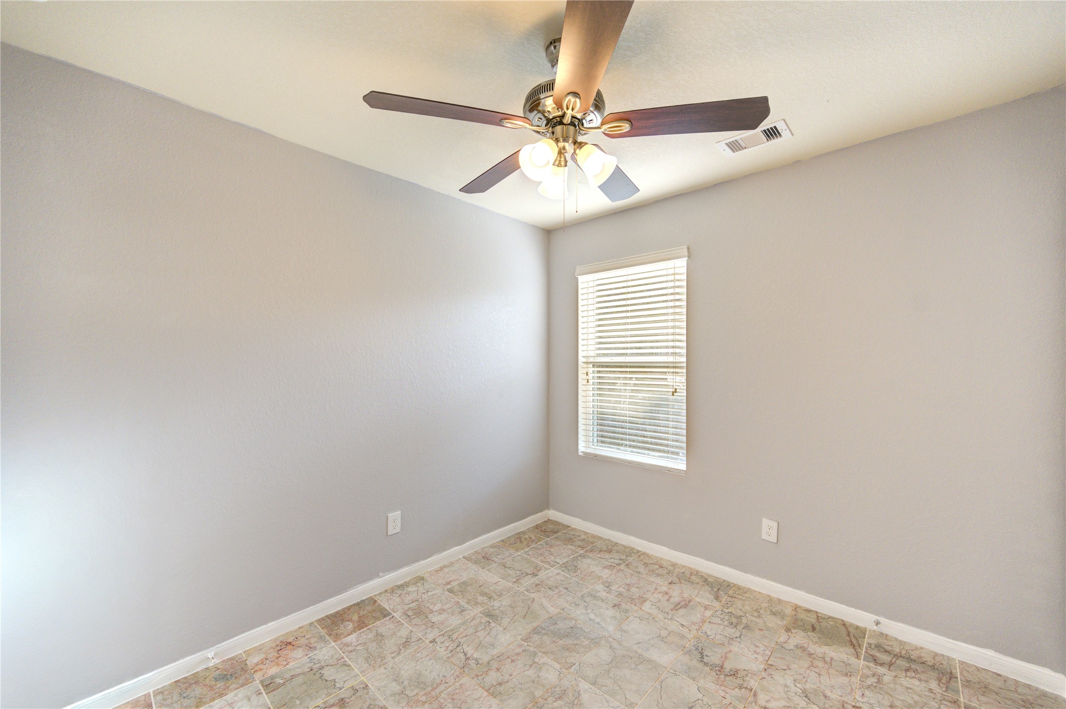 2102 Indian Clearing Trail Rosenberg, TX 77471 - Photo 27 of 29 an empty room with a window and a fan