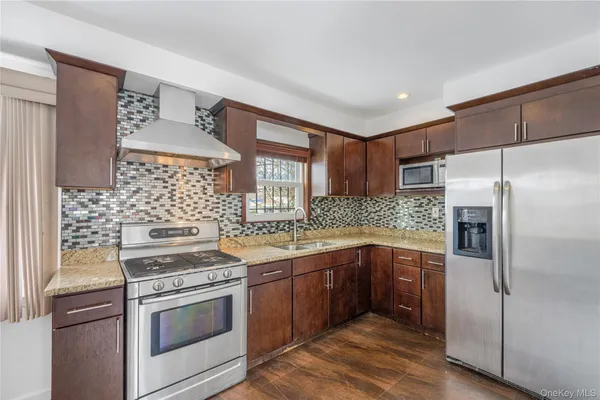 a kitchen with stainless steel appliances granite countertop a stove and a refrigerator