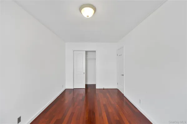 a view of a room with wooden floor and white walls