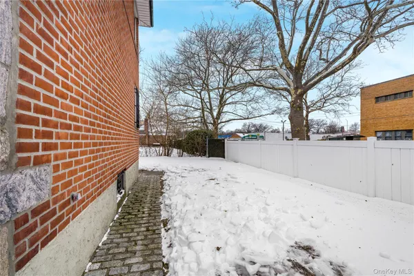 a view of a backyard with snow on the road